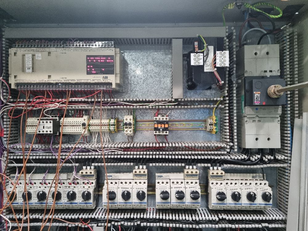 Photo of a control panel looking a mess with wires everywhere